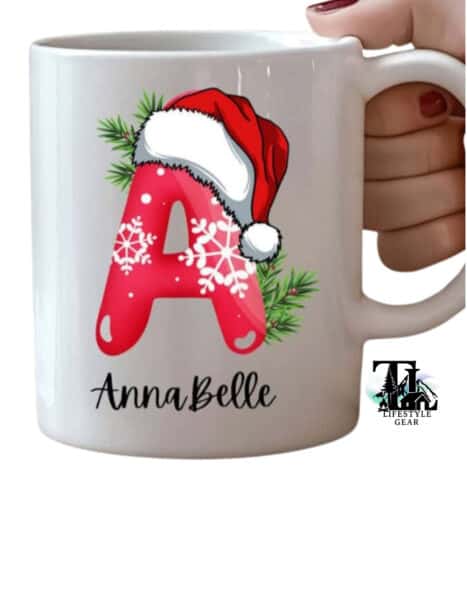 White 12 oz ceramic kids mug with christmas initial customized. Letter A with Santa Hat and snowflake pattern bubble font. Christmas aesthetic