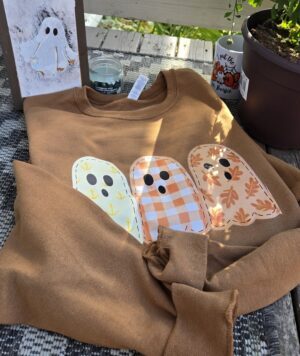 Coastal spirit golden pecan fall essential crewneck with fleece lined inside and coastal ghost print. Design has coastal aesthetic and pastel hues perfect for celebrating maritime pride with Tamarack Atlantic.