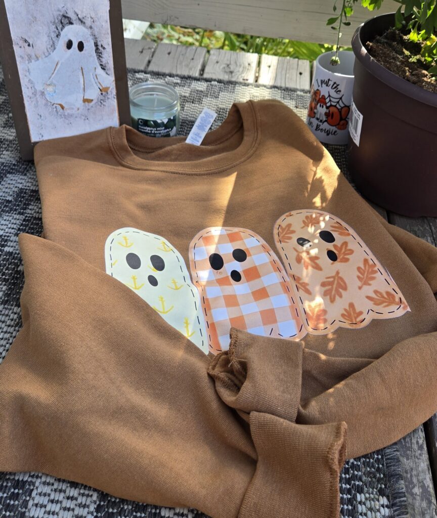 Coastal spirit golden pecan fall essential crewneck with fleece lined inside and coastal ghost print. Design has coastal aesthetic and pastel hues perfect for celebrating maritime pride with Tamarack Atlantic.